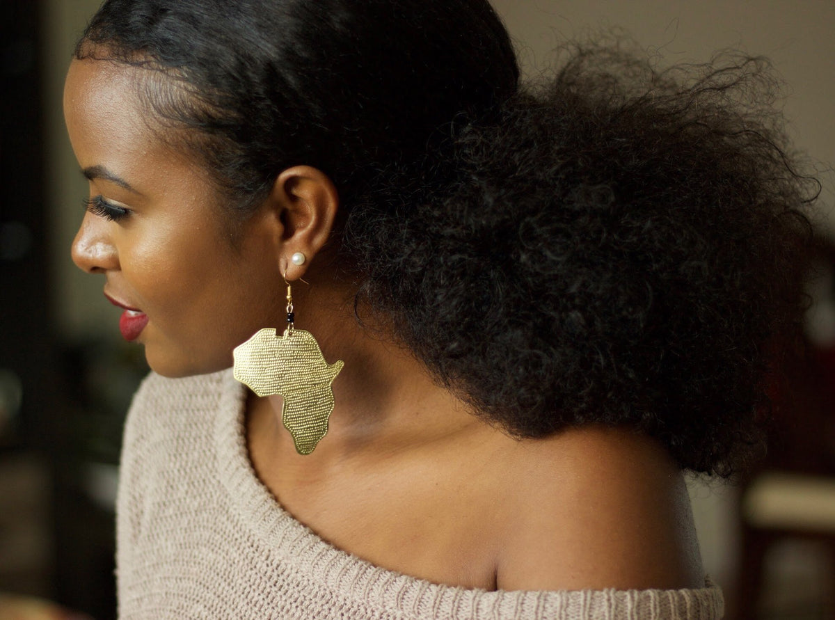 Woman wearing Maridadi Africa map jewelry in hand-embossed brass