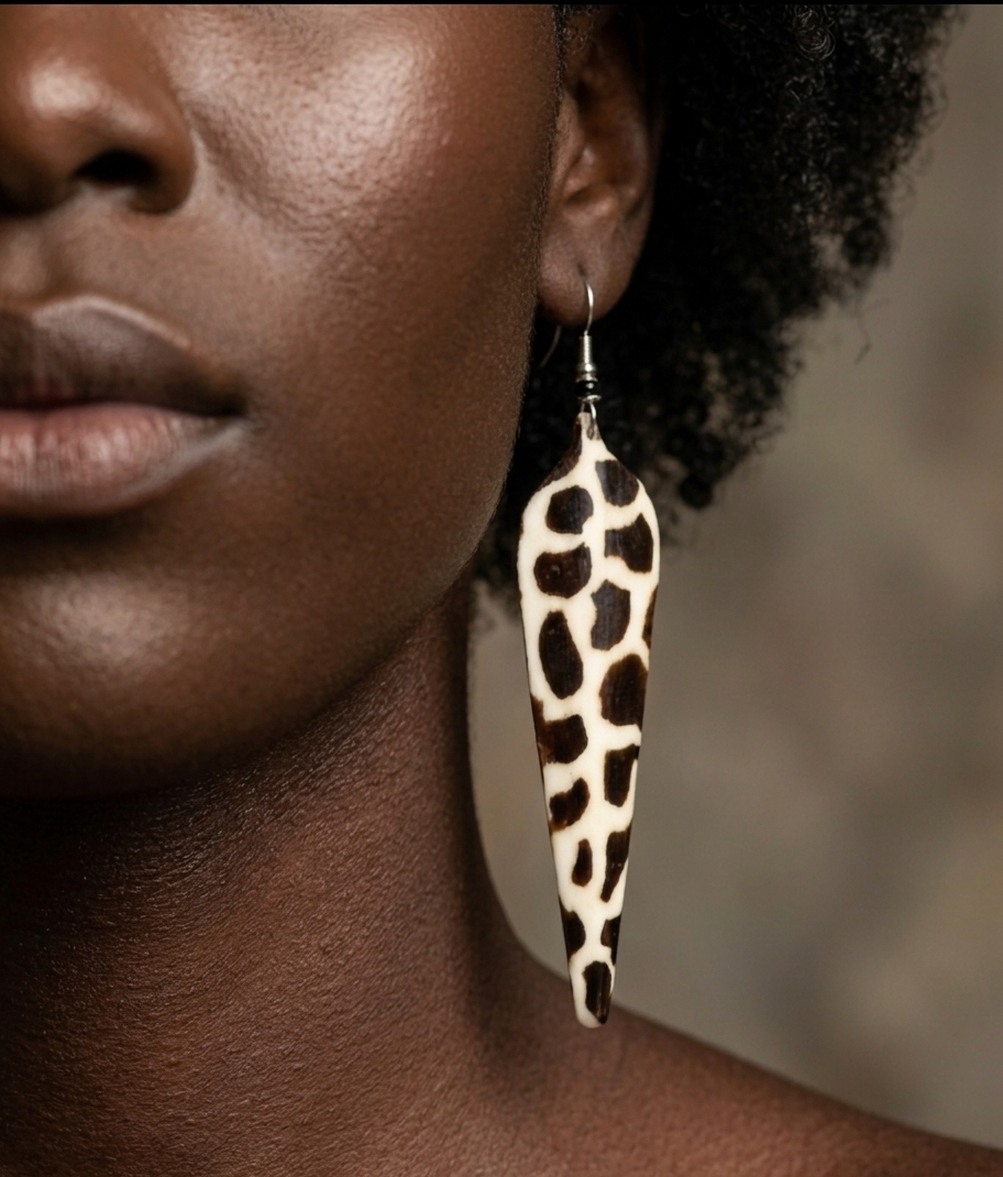 Close-up of a person wearing a leopard print African earring with a blurred background