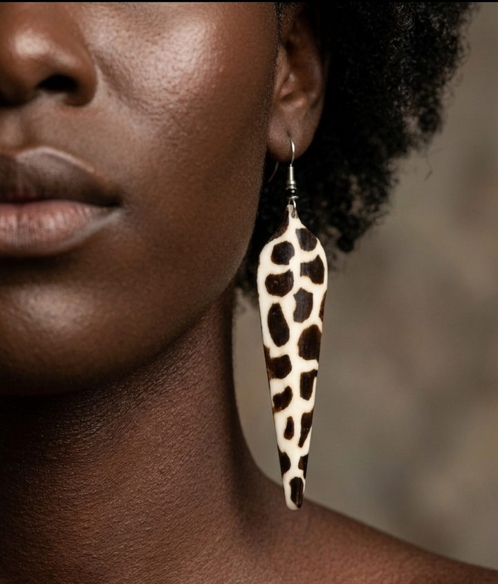Close-up of a person wearing a leopard print African earring with a blurred background